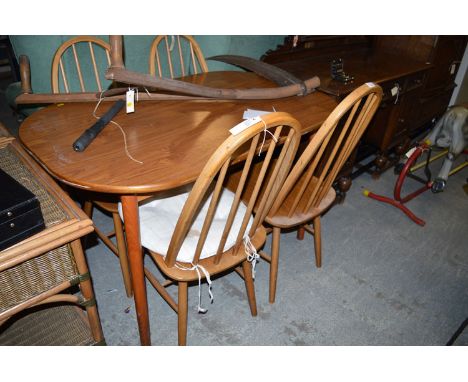 An oval stained wood table on turned wooden legs; together with a set of four Ercol style dining chairs with solid seats and 