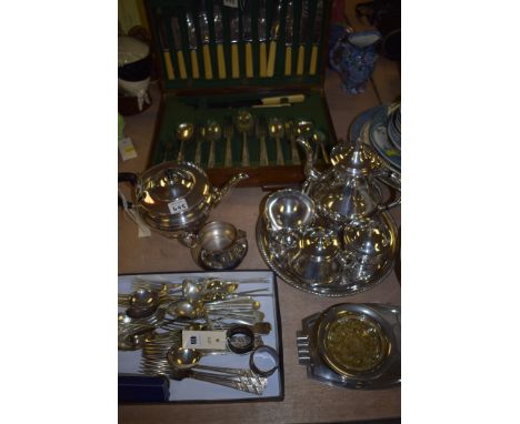 A canteen of silver plated cutlery in an oak case, four piece silver plated tea service on circular tray, teapot and sugar an