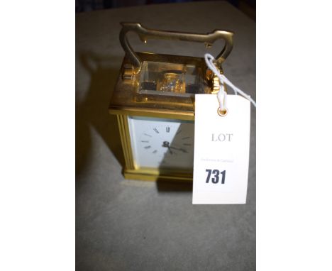 An Imperial brass cased carriage clock with platform escapement and roman white enamel dial.