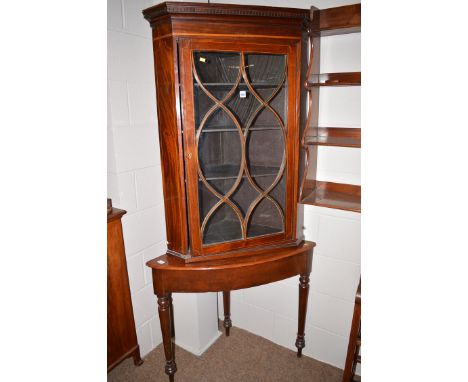 A 19th Century inlaid mahogany corner display cabinet with flared dental cornice over glazed panel door with decorative inlay