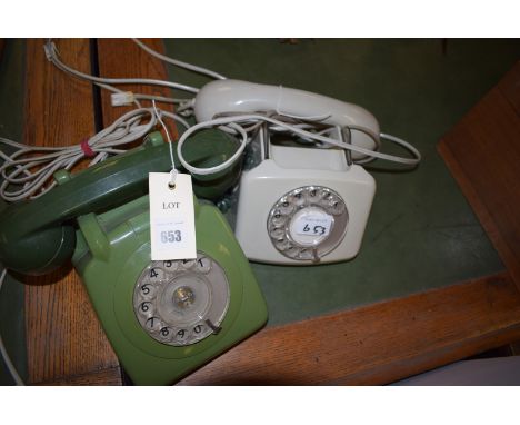 Two vintage bakelite telephones, one in green, the other in grey.