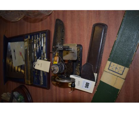 A cased drawing set; a miniature singer sewing machine; a dagger; two rules; etc.