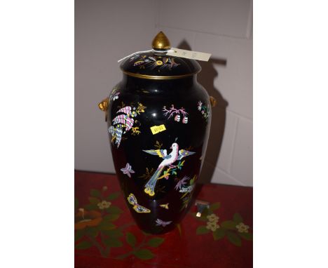 Possibly Staffordshire: earthenware vase and cover with enamel decoration on black ground.