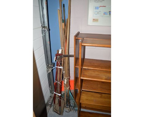 A quantity of tools including a rake, hoe, shovel, etc.