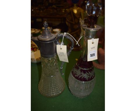 A ruby overlay cut glass decanter with silver mount; together with a pressed glass decanter with plated mount.  (2)