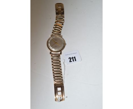 A 9ct. yellow gold cased wristwatch by Rotary, fitted automatic movement and arabic/baton dial, on a link strap.