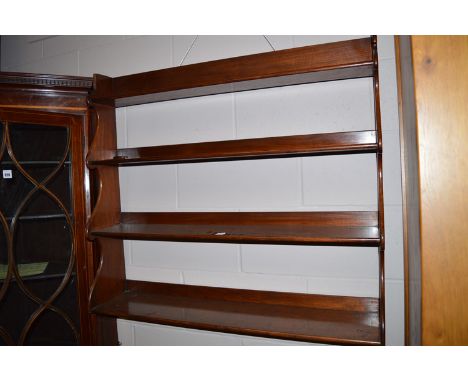 A mahogany graduating four tier wall mounted shelf unit.