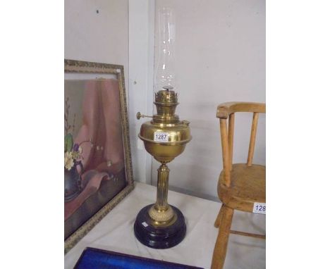 A brass oil lamp with drop in font and complete with chimney, COLLECT ONLY.
