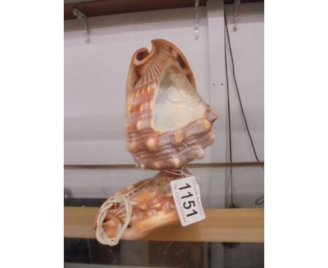 A carved cameo shell lamp featuring a mermaid.
