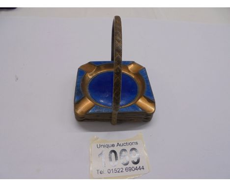 A copper and enamel ashtray stand with four ashtrays.