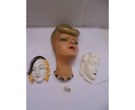 Two ceramic art deco lady wall masks and a plaster wall mask.