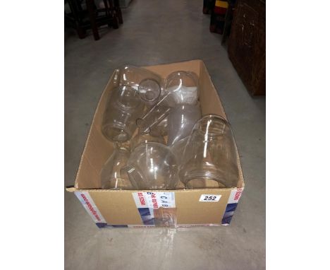 A box of oil lamp chimneys storm lanterns shades etc COLLECT ONLY 