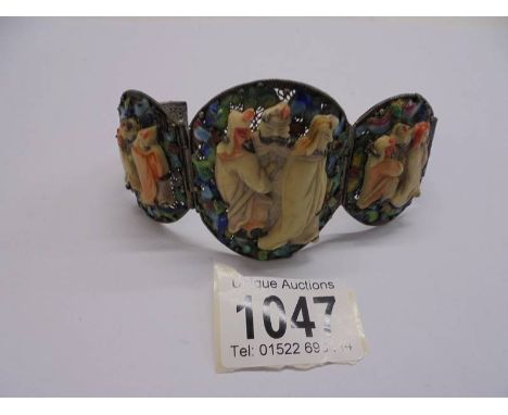 An old Chinese bangle featuring Chinese figures. The bangle snaps closed, both blue enamelled chinese miniatures on either en