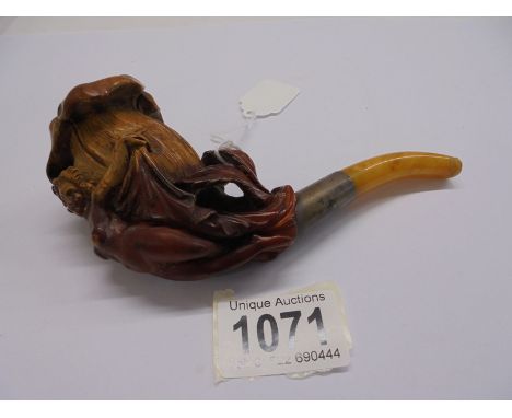A vintage pipe featuring a nude figure.