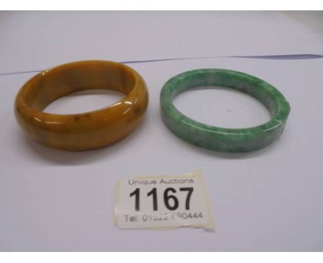 A jade bangle and a bakelite bangle.