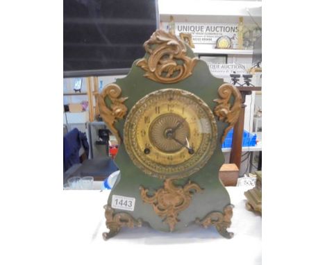 An early 20th century french heavy iron mantle clock, in working order. COLLECT ONLY.