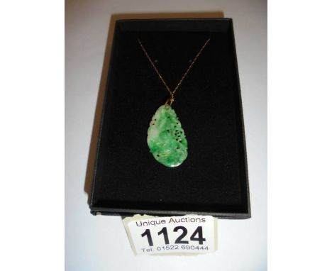 A jade pendant on a 9ct gold chain.