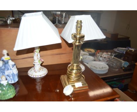 A brass table lamp and two floral encrusted china table lamps with shades 