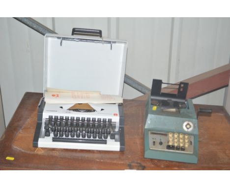 An Olympia portable typewriter and a calculating machine