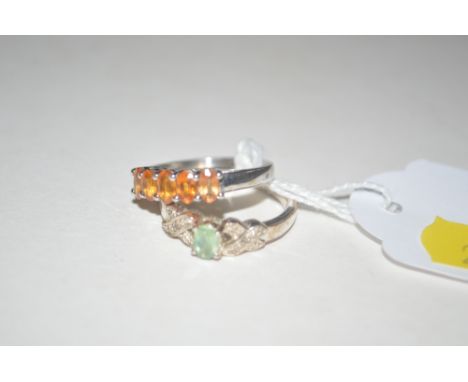 A silver orange stone set dress ring; and a white metal green stone set ring 