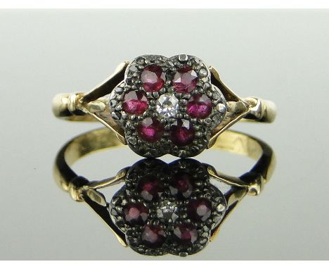 18ct gold ruby and diamond cluster ring,
setting height 10mm, size T.