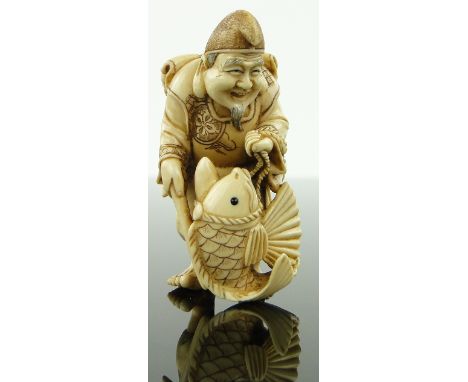 Japanese carved ivory netsuke,
man with a fish, 1.8".