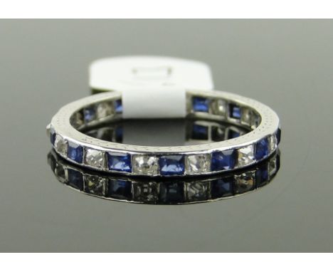 A platinum sapphire and diamond eternity ring, 
size K.