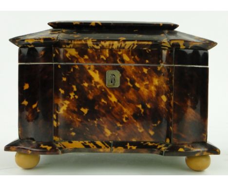 A 19th century tortoiseshell tea caddy
of shaped form, with ivory mounts, fitted interior and caddy spoon, length 7.5".