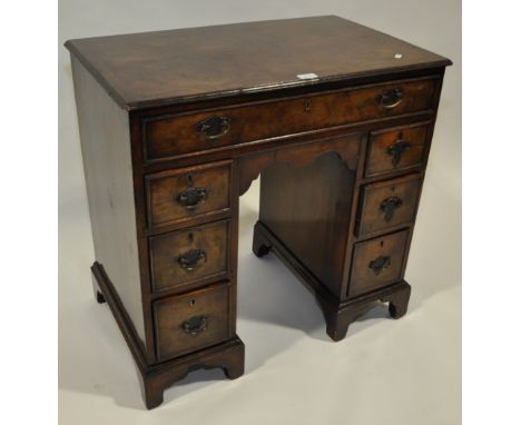 A 19th century walnut knee hole desk of small size,
having crossbanded top with 7 fitted drawers, bracket feet, width 2'6", h