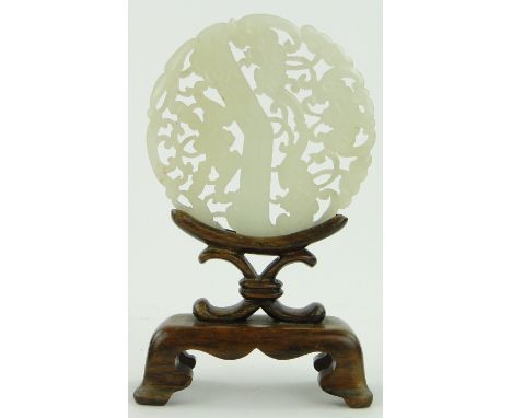 A carved and pierced jade panel
on fitted stand, height 4.75" overall.