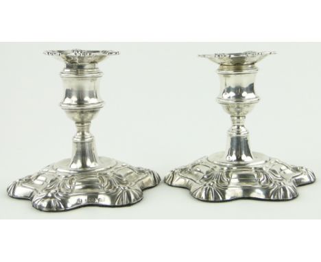 Pair of Victorian short silver candlesticks,
with shaped and scrolled bases and engrave armorial crests, makers marks W K & C