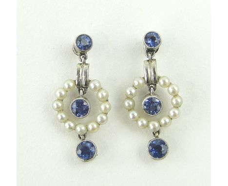 A pair of sapphire and seed pearl set pendant earrings,
unmarked white gold settings, length 25mm.