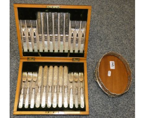 A George III silver cruet base, marks worn together with a Victorian set of electroplated dessert knives and forks with mothe