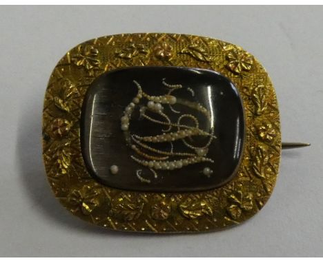 A Georgian gold, pearl and hair mourning brooch