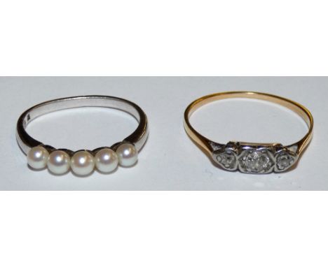 An 18ct gold three stone diamond ring and a pearl dress ring (2)