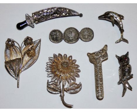 A silver owl brooch, a similar dolphin brooch, various silver filigree brooches and a Chinese silver brooch