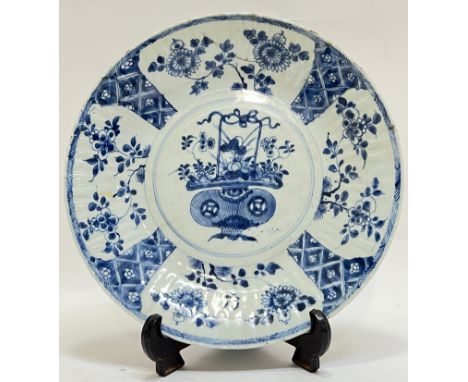 A Qing Dynasty Chinese blue and white porcelain Kangxi period scalloped dish decorated with central roundal with basket of fl