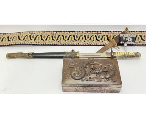 A mixed lot comprising an ornately decorated Middle Eastern belt with silver/gold-tone thread (l- 107cm), two daggers/knives 
