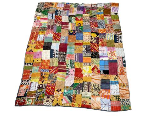 An 1920/30s patchwork quilt worked with Indian printed fabric panels backed with blue cotton fabric no tears or damge&nbsp; L