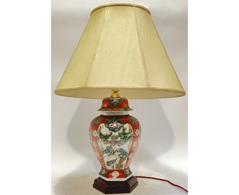 A Japanese porcelain hexagonal jar/lamp typically decorated in polychrome enamels with cranes and floral motifs, raised on a 