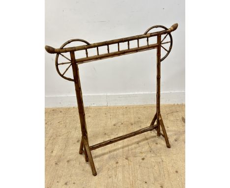 A late Victorian bamboo firescreen of Japanese inspired Temple gate design raised on triangular splay supports H x 99cm L x 1