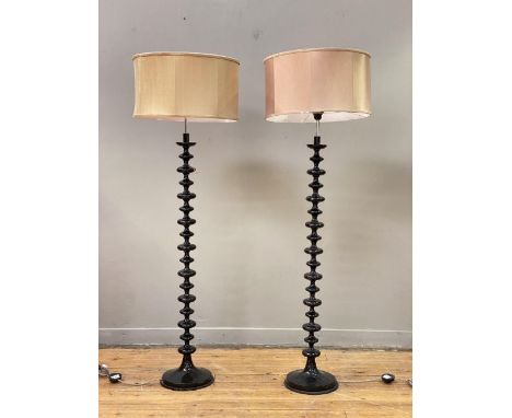 A pair of contemporary lamp standards of bobbin form, complete with cylindrical shades. H160cm.&nbsp;