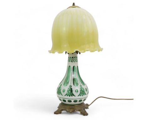 Early 20th century Bohemian green and white glass overlaid table lamp, of bulbous form with tapering neck, decorated with flo