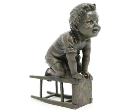 After Juan Clara (Spanish 1875-1957) - Bronze of a child playing on an upturned stool H15cm, signed underneath stool