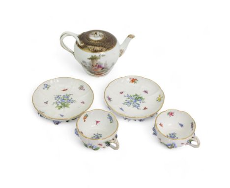 Pair of Meissen tea cups and saucers, encrusted with forget-me-nots and decorated with flowers and insects, raised on peg fee
