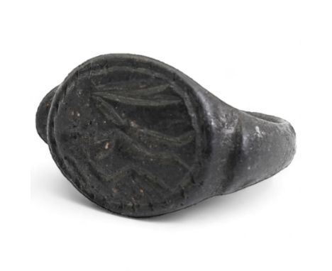 Bronze seal ring, possibly Roman, with D shaped hoop and angled shoulders, the bezel engraved with a figure, possibly on hors