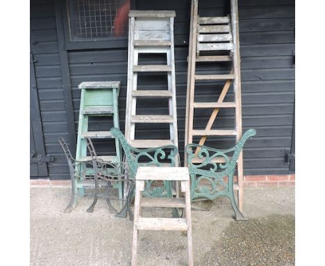 Four various step ladders, together with a pair of iron bench ends
