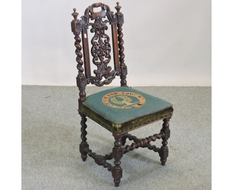 A 19th century carved oak hall chair, with a green tapestry seat