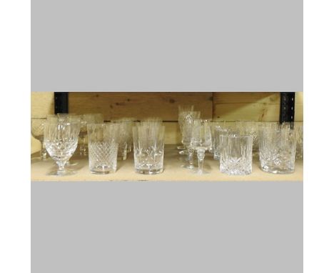 A shelf of cut glass drinking glasses, to include Edinburgh crystal