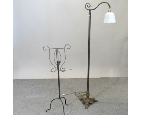 A brass standard lamp with a white glass shade, 168cm high, together with a metal music stand
